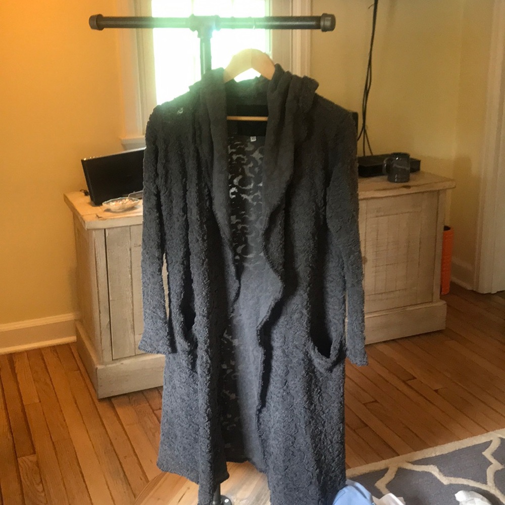Calf length sweater with pockets and a hood.